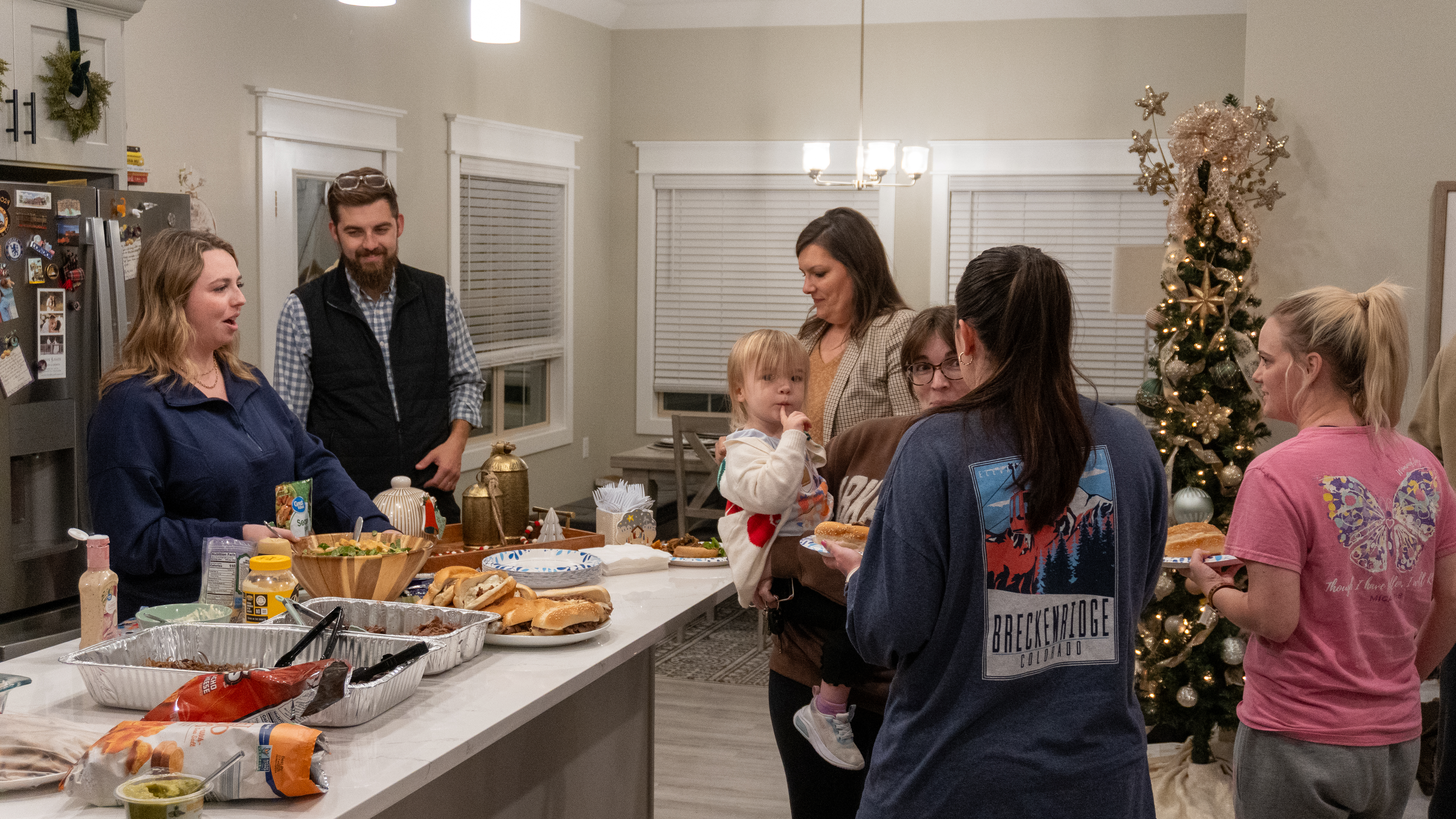 Members of the Garner/Patterson group laugh whilst serving themselves dinner.