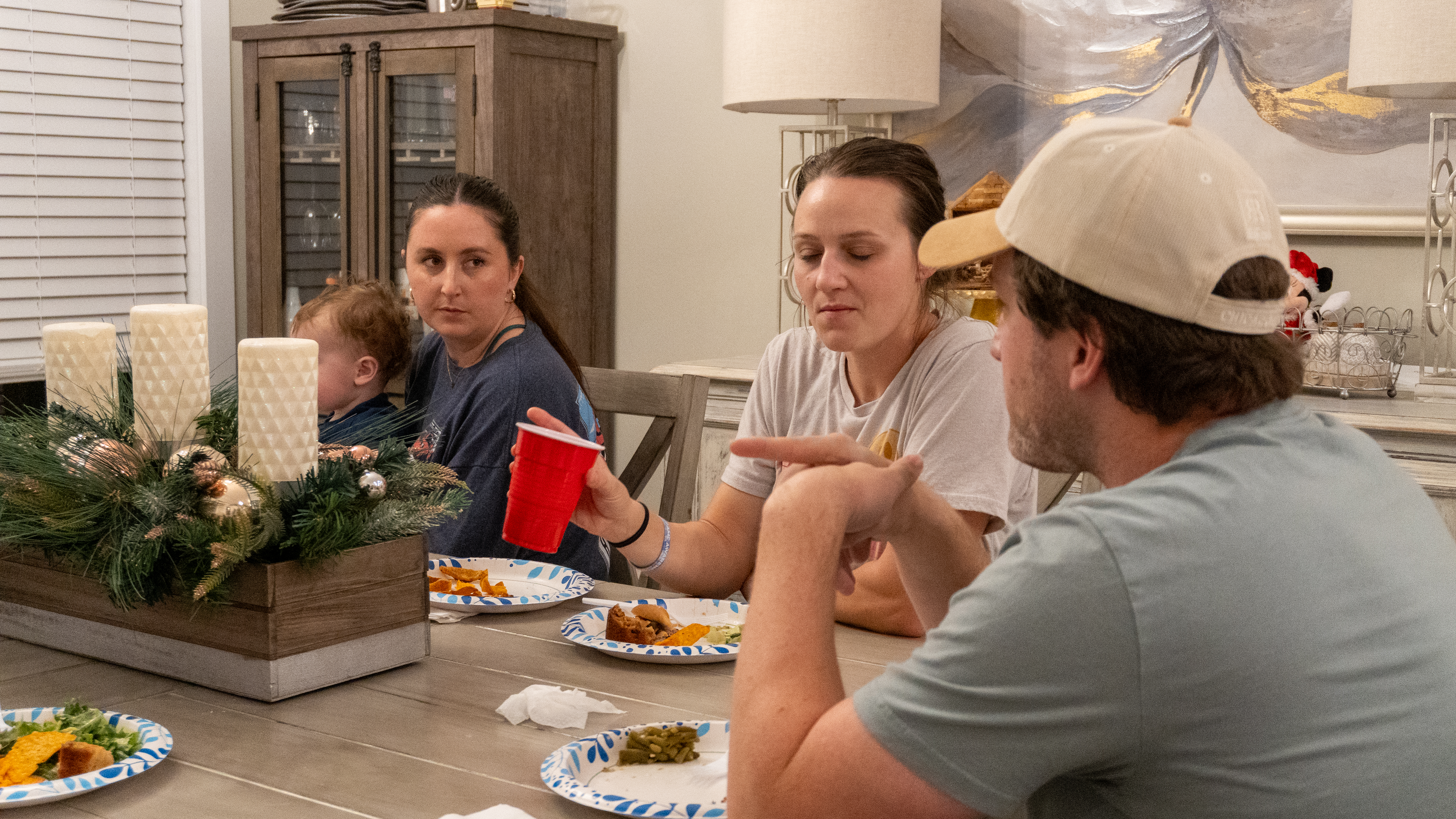 Warren Younge, Lyric Holloway, and Jade Hawkins talk over a meal.