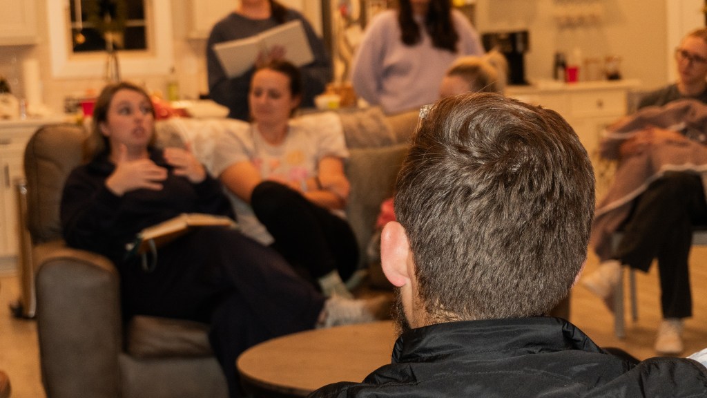 Pastor Daniel White listens to testimony from Erica Garner.